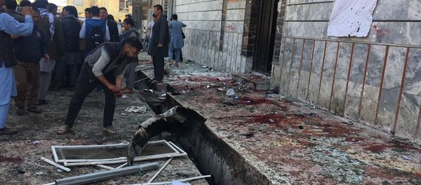 People gather outside a voter registration center, which was attacked by a suicide bomber in Kabul, Sunday, April 22, 2018 - Sputnik International