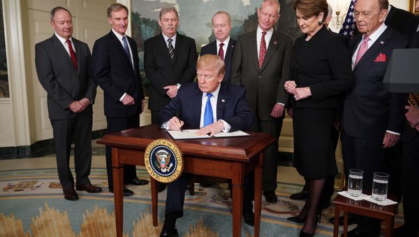 US President Donald Trump signs trade sanctions against China on March 22, 2018, in the Diplomatic Reception Room of the White House in Washington, DC, on March 22, 2018. Trump will impose tariffs on about $50 billion in Chinese goods imports to retaliate against the alleged theft of American intellectual property, White House officials said Thursday US President Donald Trump signs trade sanctions against China on March 22, 2018, in the Diplomatic Reception Room of the White House in Washington, DC, on March 22, 2018. Trump will impose tariffs on about $50 billion in Chinese goods imports to retaliate against the alleged theft of American intellectual property, White House officials said Thursday - Sputnik International