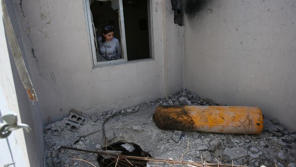 A journalist looks on during a media tour of a damaged house where Organisation for the Prohibition of Chemical Weapons (OPCW) inspectors are belived to have visited in Douma near Damascus, Syria April 23, 2018 - Sputnik International