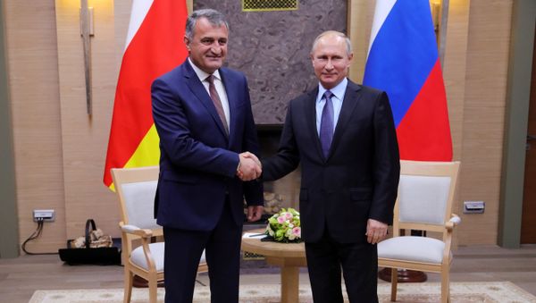 Russian President Vladimir Putin and President of South Ossetia Anatoly Bibilov, left, during a meeting. File photo - Sputnik International