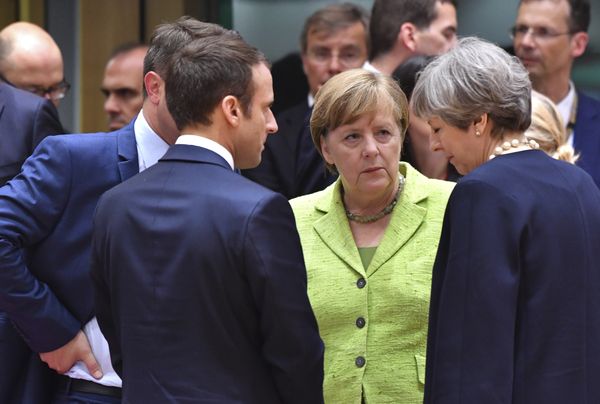 French President Emmanuel Macron, second left, speaks with German Chancellor Angela Merkel, center, and British Prime Minister Theresa May, right, during a round table meeting at an EU summit in Brussels on Thursday, June 22, 2017 - Sputnik International
