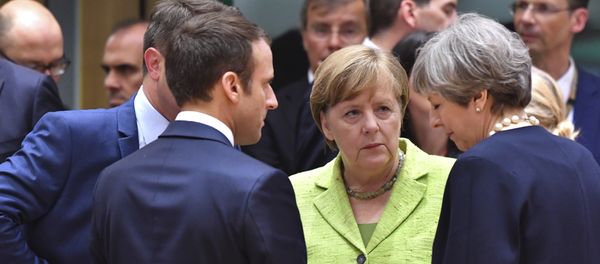 French President Emmanuel Macron, second left, speaks with German Chancellor Angela Merkel, center, and British Prime Minister Theresa May, right, during a round table meeting at an EU summit in Brussels on Thursday, June 22, 2017 - Sputnik International