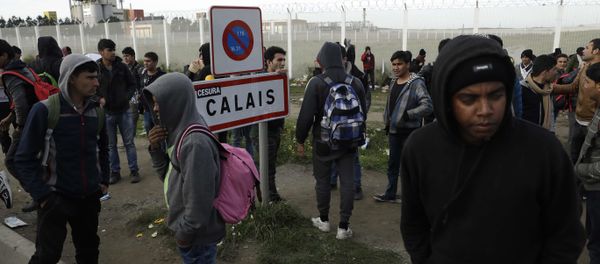 In this Thursday, Oct. 27, 2016 file photo migrants gather near a fence in Calais, northern France. In this Thursday, Oct. 27, 2016 file photo migrants gather near a fence in Calais, northern France. - Sputnik International