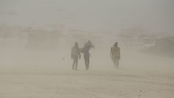 Indians walk on the banks of the river Ganges during a dust storm in Allahabad, India (File) - Sputnik International