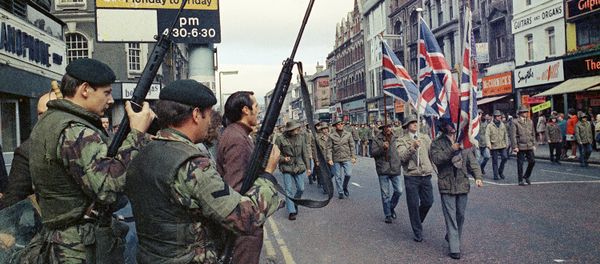 Under the watchful eyes of armed British troops, members of the Ulster Defence Association parade through Belfast, Northern Ireland in August 1972 Under the watchful eyes of armed British troops, members of the Ulster Defence Association parade through Belfast, Northern Ireland in August 1972 - Sputnik International