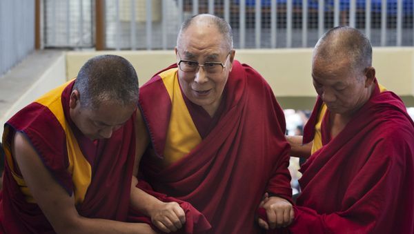 Tibetan spiritual leader the Dalai Lama is helped up the stairs by attendant monks as he arrives to participate in a dialogue between Russian scientists and Buddhist scholar at the Tsuglakhang temple in Dharmsala, India, Friday, May 4, 2018 - Sputnik International