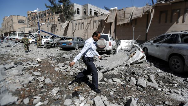 A man walks past damaged cars outside the Presidential Compound after it was hit by air strikes in Sanaa, Yemen May 7, 2018 A man walks past damaged cars outside the Presidential Compound after it was hit by air strikes in Sanaa, Yemen May 7, 2018 - Sputnik International