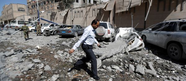 A man walks past damaged cars outside the Presidential Compound after it was hit by air strikes in Sanaa, Yemen May 7, 2018 A man walks past damaged cars outside the Presidential Compound after it was hit by air strikes in Sanaa, Yemen May 7, 2018 - Sputnik International
