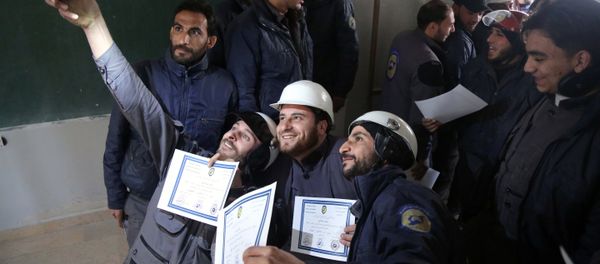 Members of the Syrian Civil Defence, known as the White Helmets, take a selfie with their certificates after taking part in a training session in the rebel-held eastern Ghouta area, east of the capital Damascus, on November 22, 2016 Members of the Syrian Civil Defence, known as the White Helmets, take a selfie with their certificates after taking part in a training session in the rebel-held eastern Ghouta area, east of the capital Damascus, on November 22, 2016 - Sputnik International