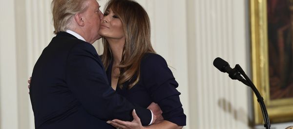 President Donald Trump kisses first lady Melania Trump during a celebration of military mothers and spouses event in the East Room of the White House in Washington, Wednesday, May 9, 2018 - Sputnik International