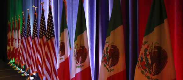 FILE - In this Aug. 16, 2017 file photo, the national flags of Canada, from left, the U.S. and Mexico, are lit by stage lights before a news conference, at the start of North American Free Trade Agreement renegotiations in Washington D.C. Mexico appears to be preparing for the worst as the fourth round of talks open in Washington D.C, Wednesday, Oct. 11, 2017 FILE - In this Aug. 16, 2017 file photo, the national flags of Canada, from left, the U.S. and Mexico, are lit by stage lights before a news conference, at the start of North American Free Trade Agreement renegotiations in Washington D.C. Mexico appears to be preparing for the worst as the fourth round of talks open in Washington D.C, Wednesday, Oct. 11, 2017 - Sputnik International