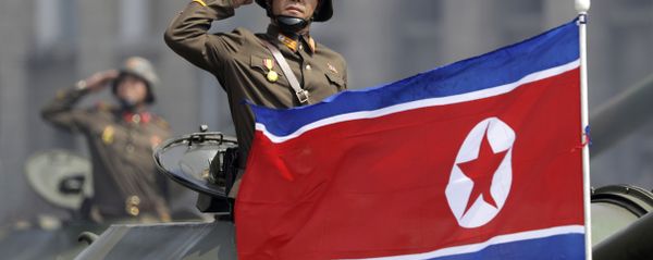 In this Saturday, April 15, 2017, file photo, a North Korean national flag flutters as soldiers in tanks salute to North Korean leader Kim Jong Un during a military parade in Pyongyang, North Korea to celebrate the 105th birth anniversary of Kim Il Sung, the country's late founder and grandfather of the current ruler In this Saturday, April 15, 2017, file photo, a North Korean national flag flutters as soldiers in tanks salute to North Korean leader Kim Jong Un during a military parade in Pyongyang, North Korea to celebrate the 105th birth anniversary of Kim Il Sung, the country's late founder and grandfather of the current ruler - Sputnik International