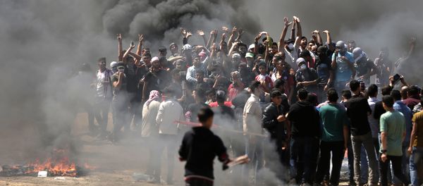 Palestinian demonstrators burn tyres near the Gaza-Israel border, east of Gaza City, as Palestinians readied for protests over the inauguration of the US embassy following its controversial move to Jerusalem on May 14, 0218 Palestinian demonstrators burn tyres near the Gaza-Israel border, east of Gaza City, as Palestinians readied for protests over the inauguration of the US embassy following its controversial move to Jerusalem on May 14, 0218 - Sputnik International