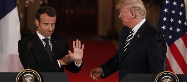 French President Emmanuel Macron waves to someone in the crowd as he and U.S. President Donald Trump conclude their joint news conference in the East Room of the White House in Washington, U.S., April 24, 2018 - Sputnik International