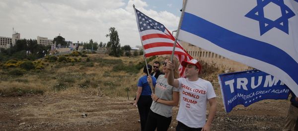 Israelis hold American and Israeli flags with the new U.S. embassy in the background in Jerusalem, Monday, May 14, 2018 Israelis hold American and Israeli flags with the new U.S. embassy in the background in Jerusalem, Monday, May 14, 2018 - Sputnik International