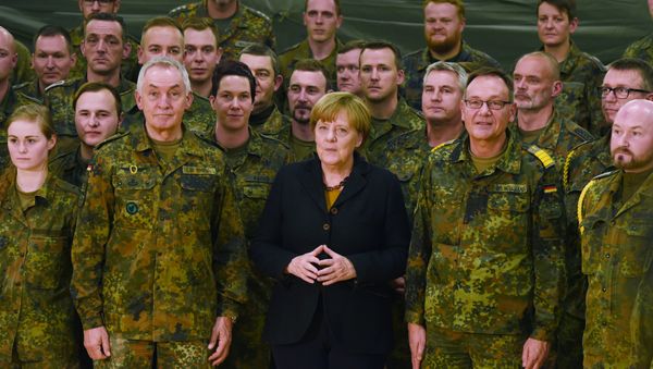 German chancellor Angela Merkel (C) poses next to Surgeon General Michael Tempel (L) and commander Dirk Moellmann (2L) and members of the German army Rapid Medical Response Forces Command in Leer, northern Germany, on December 7, 2015 German chancellor Angela Merkel (C) poses next to Surgeon General Michael Tempel (L) and commander Dirk Moellmann (2L) and members of the German army Rapid Medical Response Forces Command in Leer, northern Germany, on December 7, 2015 - Sputnik International