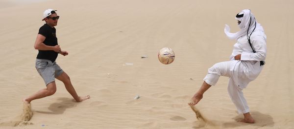 Playing football in the desert of Khor Al Adaid, Doha, State of Qatar. - Sputnik International