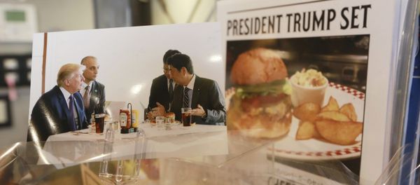 A photo showing U.S. President Donald Trump, left, and Japanese Prime Minister Shinzo Abe, right, at a lunch of hamburgers from Munch's Burger Shack at Kasumigaseki Country Club, is displayed at the burger restaurant in Tokyo Thursday, Nov. 16, 2017 A photo showing U.S. President Donald Trump, left, and Japanese Prime Minister Shinzo Abe, right, at a lunch of hamburgers from Munch's Burger Shack at Kasumigaseki Country Club, is displayed at the burger restaurant in Tokyo Thursday, Nov. 16, 2017 - Sputnik International