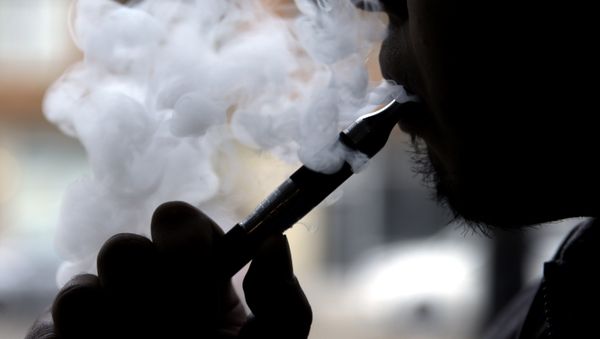 FILE - In this April 23, 2014 file photo, a man smokes an electronic cigarette in Chicago. FILE - In this April 23, 2014 file photo, a man smokes an electronic cigarette in Chicago. - Sputnik International