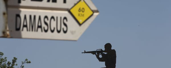 A mock road sign for Damascus, the capital of Syria, and a cutout of a soldier, are displayed in an old outpost in the Israeli controlled Golan Heights near the border with Syria, Thursday, May 10, 2018 A mock road sign for Damascus, the capital of Syria, and a cutout of a soldier, are displayed in an old outpost in the Israeli controlled Golan Heights near the border with Syria, Thursday, May 10, 2018 - Sputnik International