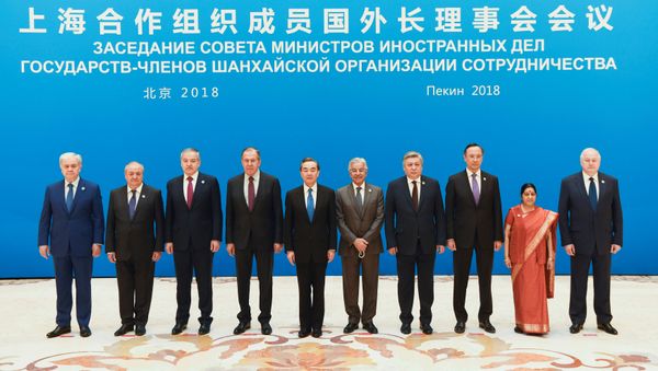 Foreign ministers and officials of the Shanghai Cooperation Organisation (SCO) pose for a group photo before a meeting at the Diaoyutai State Guest House in Beijing, China, April 24, 2018. Foreign ministers and officials of the Shanghai Cooperation Organisation (SCO) pose for a group photo before a meeting at the Diaoyutai State Guest House in Beijing, China, April 24, 2018. - Sputnik International