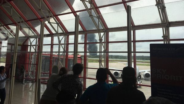 People watch as smoke rises from the site where a plane crashed shortly after taking off from Havana, Cuba, May 18, 2018, in this photo in obtained from social media - Sputnik International