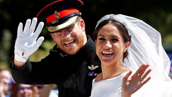 Britain’s Prince Harry and his wife Meghan wave as they ride a horse-drawn carriage after their wedding ceremony at St George’s Chapel in Windsor Castle in Windsor, Britain, May 19, 2018 Britain’s Prince Harry and his wife Meghan wave as they ride a horse-drawn carriage after their wedding ceremony at St George’s Chapel in Windsor Castle in Windsor, Britain, May 19, 2018 - Sputnik International
