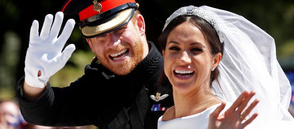 Britain’s Prince Harry and his wife Meghan wave as they ride a horse-drawn carriage after their wedding ceremony at St George’s Chapel in Windsor Castle in Windsor, Britain, May 19, 2018 Britain’s Prince Harry and his wife Meghan wave as they ride a horse-drawn carriage after their wedding ceremony at St George’s Chapel in Windsor Castle in Windsor, Britain, May 19, 2018 - Sputnik International