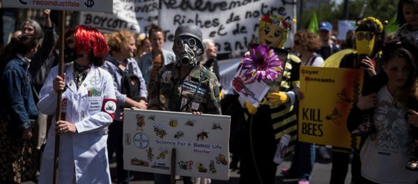 People take part in a demonstration to protest against industrial giants Monsanto, Bayer and Syngenta at the Place de la Republique in Paris on May 19, 2018 - Sputnik International
