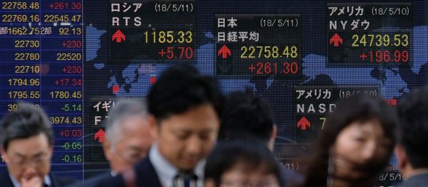 Pedestrians walk past a stock indicator showing share prices of the Tokyo Stock Exchange (top-C) and other overseas stock markets in Tokyo on May 11, 2018 Pedestrians walk past a stock indicator showing share prices of the Tokyo Stock Exchange (top-C) and other overseas stock markets in Tokyo on May 11, 2018 - Sputnik International