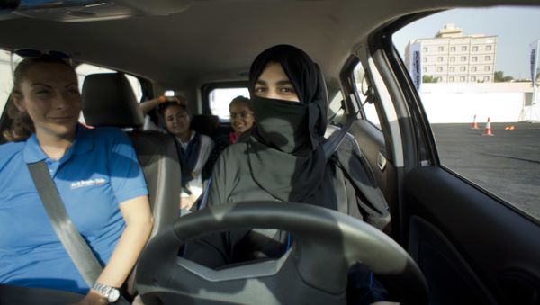Razan, right, sits for the first time in the driver's seat, with her trainer Francesca Pardini, an Italian ex-race car driver, during training sponsored by Ford Motor, in Jiddah, Saudi Arabia, Tuesday, March 6, 2018. A stunning royal decree issued last year by King Salman announcing that women would be allowed to drive in 2018 upended one of the most visible forms of discrimination against women in Saudi Arabia. Razan, right, sits for the first time in the driver's seat, with her trainer Francesca Pardini, an Italian ex-race car driver, during training sponsored by Ford Motor, in Jiddah, Saudi Arabia, Tuesday, March 6, 2018. A stunning royal decree issued last year by King Salman announcing that women would be allowed to drive in 2018 upended one of the most visible forms of discrimination against women in Saudi Arabia. - Sputnik International