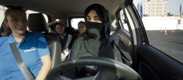 Razan, right, sits for the first time in the driver's seat, with her trainer Francesca Pardini, an Italian ex-race car driver, during training sponsored by Ford Motor, in Jiddah, Saudi Arabia, Tuesday, March 6, 2018. A stunning royal decree issued last year by King Salman announcing that women would be allowed to drive in 2018 upended one of the most visible forms of discrimination against women in Saudi Arabia. - Sputnik International