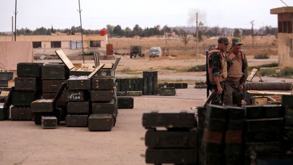 Russian soldiers stand next to boxes of ammunition and weapons, that belonged to rebels from Eastern Qalamoun, after they handed them over, at the town of Dumayr, Damascus, Syria, April 22, 2018 - Sputnik International