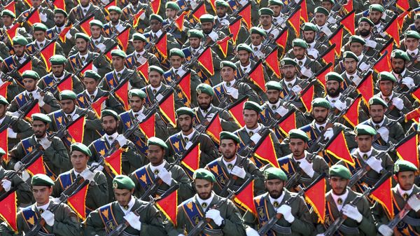In this Sept. 21, 2016 file photo, Iran's Revolutionary Guard troops march in a military parade marking the 36th anniversary of Iraq's 1980 invasion of Iran, in front of the shrine of late revolutionary founder Ayatollah Khomeini, just outside Tehran, Iran In this Sept. 21, 2016 file photo, Iran's Revolutionary Guard troops march in a military parade marking the 36th anniversary of Iraq's 1980 invasion of Iran, in front of the shrine of late revolutionary founder Ayatollah Khomeini, just outside Tehran, Iran - Sputnik International