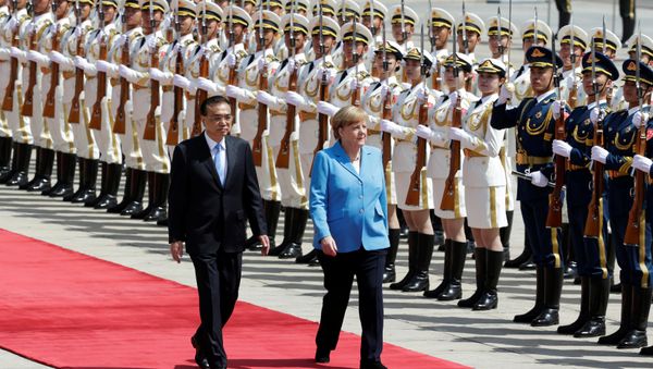 German Chancellor Angela Merkel and Chinese Premier Li Keqiang review the guard of honour during a welcome ceremony outside the Great Hall of the People in Beijing, China May 24, 2018 German Chancellor Angela Merkel and Chinese Premier Li Keqiang review the guard of honour during a welcome ceremony outside the Great Hall of the People in Beijing, China May 24, 2018 - Sputnik International