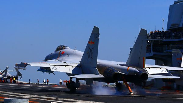 This photo taken on April 24, 2018 shows a J15 fighter jet landing on China's sole operational aircraft carrier, the Liaoning, during a drill at sea This photo taken on April 24, 2018 shows a J15 fighter jet landing on China's sole operational aircraft carrier, the Liaoning, during a drill at sea - Sputnik International