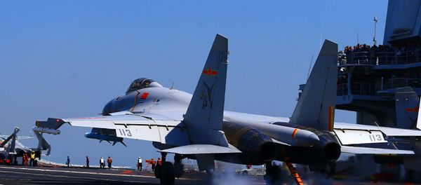 This photo taken on April 24, 2018 shows a J15 fighter jet landing on China's sole operational aircraft carrier, the Liaoning, during a drill at sea - Sputnik International