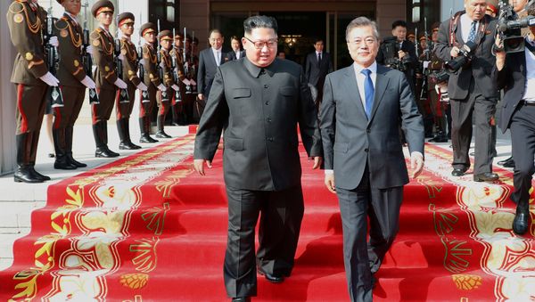 South Korean President Moon Jae-in and North Korean leader Kim Jong Un leave after their summit at the truce village of Panmunjom, North Korea, in this handout picture provided by the Presidential Blue House on May 26, 2018. Picture taken on May 26, 2018 - Sputnik International