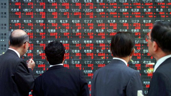 Japanese businessmen stop in front of an electronic board flashing share prices in downtown Tokyo (File) Japanese businessmen stop in front of an electronic board flashing share prices in downtown Tokyo (File) - Sputnik International
