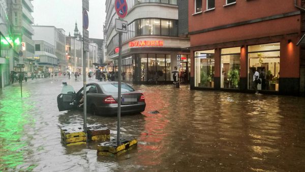 A car is stranded in the flood water following heavy rainfall in Wuppertal, western Germany on May 29, 2018 - Sputnik International