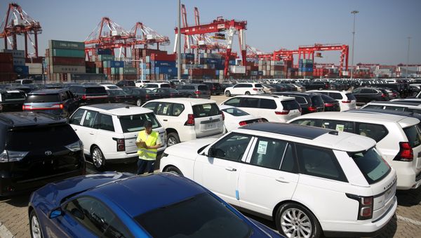 A worker inspects imported cars at a port in Qingdao, Shandong province, China May 23, 2018 A worker inspects imported cars at a port in Qingdao, Shandong province, China May 23, 2018 - Sputnik International