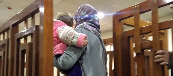 This file photo taken on February 19, 2018, shows French Jihadist Melina Boughedir carrying her son as she arrives to court in the Iraqi capital Baghdad - Sputnik International
