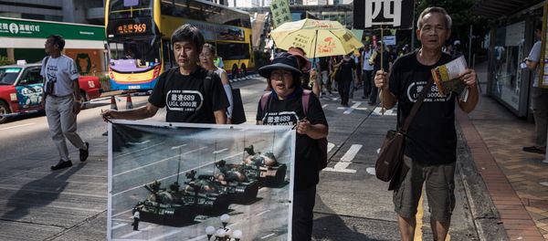 Protesters display a poster of the famous Tank Man standing in front of Chinese military tanks at Tiananmen Square in Beijing, during a rally in Hong Kong on May 28, 2017, ahead of the 28th anniversary of the June 4, 1989 Tiananmen Square crackdown Protesters display a poster of the famous Tank Man standing in front of Chinese military tanks at Tiananmen Square in Beijing, during a rally in Hong Kong on May 28, 2017, ahead of the 28th anniversary of the June 4, 1989 Tiananmen Square crackdown - Sputnik International