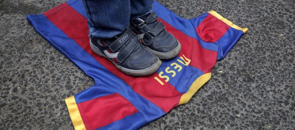(FILES) In this file photo taken on October 07, 2012, a Palestinian boy steps on a T-shirt of Spanish FC Barcelona football club with the name of it's Argentinian player, Lionel Messi, during a demonstration outside the Spanish consulate in eastern Jerusalem on October 7, 2012 to protest against Barcelona's invitation of Israeli slodier Gilad Shalit to attend today's El Clasico match (FILES) In this file photo taken on October 07, 2012, a Palestinian boy steps on a T-shirt of Spanish FC Barcelona football club with the name of it's Argentinian player, Lionel Messi, during a demonstration outside the Spanish consulate in eastern Jerusalem on October 7, 2012 to protest against Barcelona's invitation of Israeli slodier Gilad Shalit to attend today's El Clasico match - Sputnik International