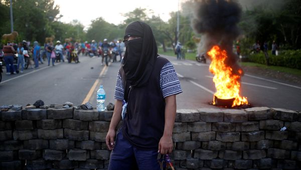A masked protester takes part in a protest against President Daniel Ortega's government in Leon, Nicaragua - Sputnik International