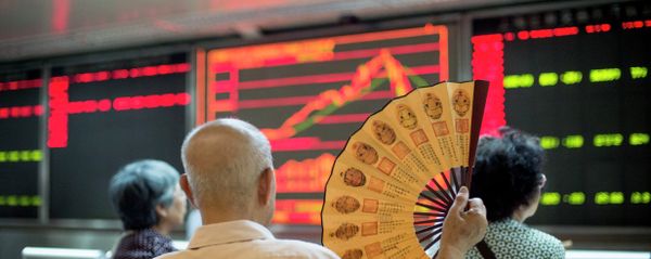 Investors look at screens showing stock market movements at a securities company in Beijing on July 28, 2015 - Sputnik International