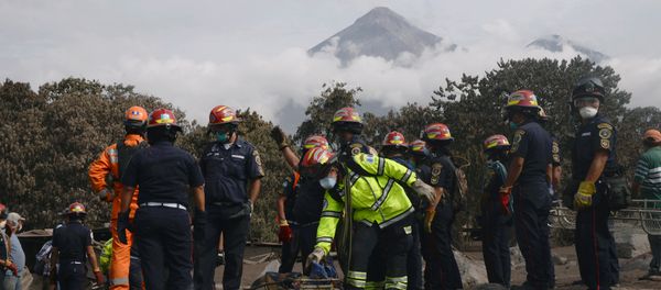 Firefighters carry the skeleton remains found buried at a house during a search at an area affected by the eruption of the Fuego volcano at El Rodeo in Escuintla - Sputnik International