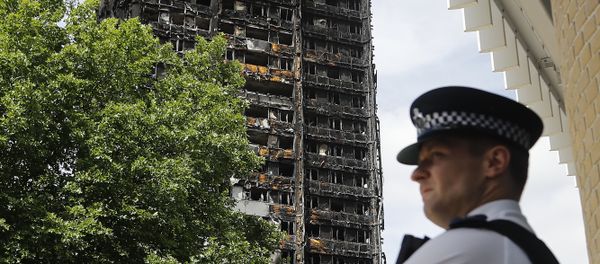 A police officer stands near to the burnt Grenfell Tower apartment building standing testament to the recent fire in London, Friday, June 23, 2017. A police officer stands near to the burnt Grenfell Tower apartment building standing testament to the recent fire in London, Friday, June 23, 2017. - Sputnik International