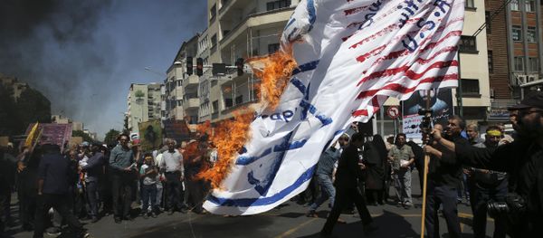 Iranian protesters burn a representation of the U.S. and Israeli flags in their annual anti-Israeli Al-Quds, Jerusalem, Day rally in Tehran, Iran, Friday, June 8, 2018 - Sputnik International