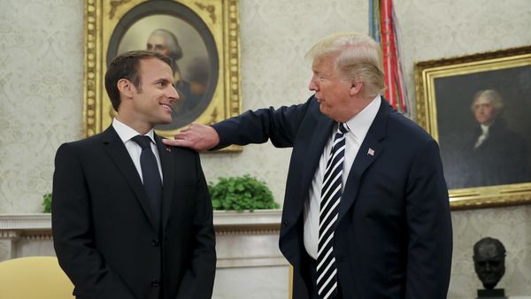 President Donald Trump playfully reaches over to cleans lint off French President Emmanuel Macron's suit jacket during their meeting in Oval Office of the White House in Washington, Tuesday, April 24, 2018 President Donald Trump playfully reaches over to cleans lint off French President Emmanuel Macron's suit jacket during their meeting in Oval Office of the White House in Washington, Tuesday, April 24, 2018 - Sputnik International